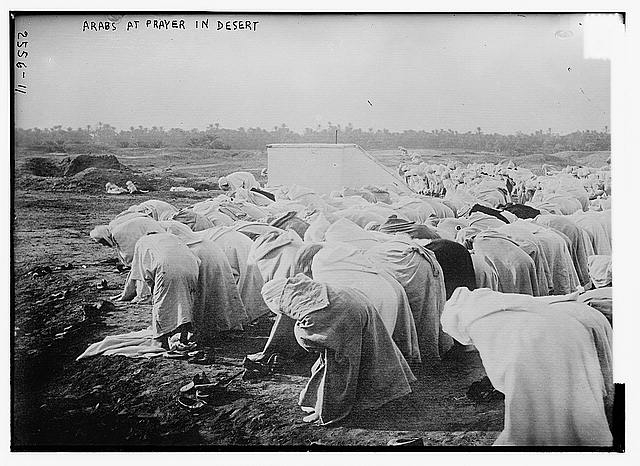 Arabs at prayer in desert