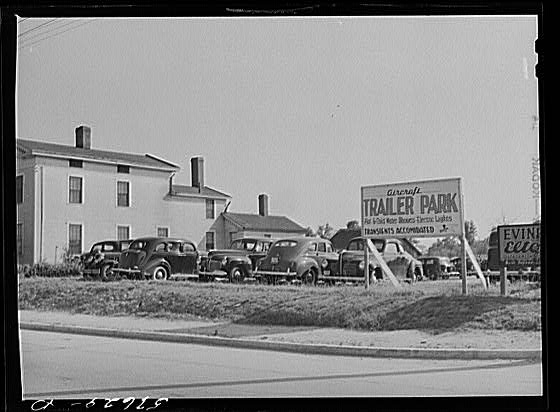 Parked cars on private yard and trailer park sign where...