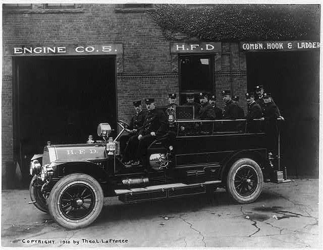 Vehicle and men of Engine Co. No. 5 in an unidentified town