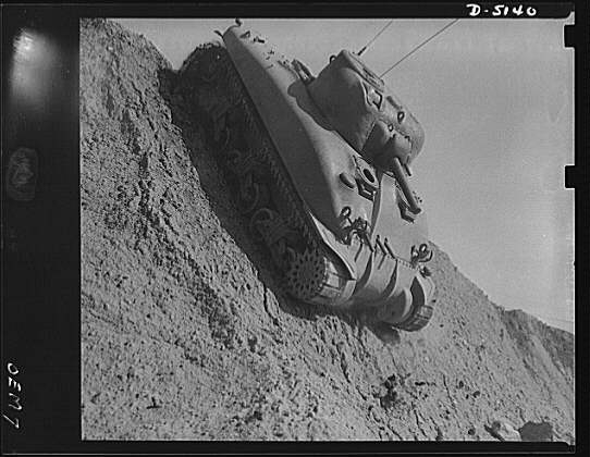 Testing M-4 tanks. Down the steep side of a test hill, as...