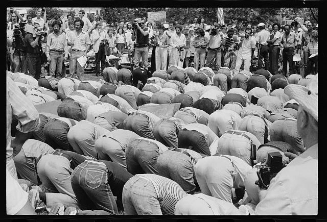 [Iranian men bow in prayer during demonstration for...