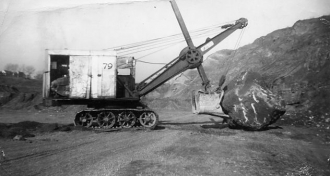 Clearing a boulder with a steam shovel