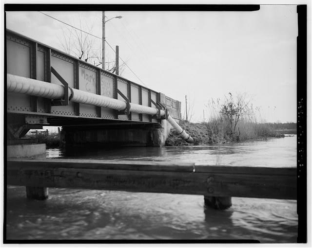 6. SIDE VIEW, LOOKING EAST AT ABUTMENT AREA AND WHEEL...