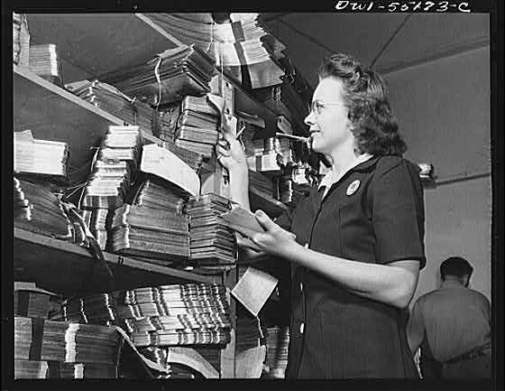A clerk in the hydropress department checks parts as they...