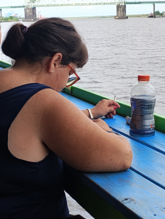 This is me sitting outside enjoying breakfast on the cape fear river. I live in Wilmington North Carolina now and have become a background actress in several movies and TV shows including Under the dome , Checkpoint and Halloween kills.