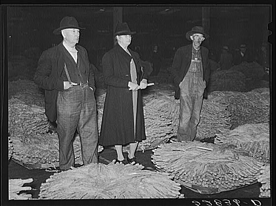 Farmer and his wife waiting for their tobacco to be sold...