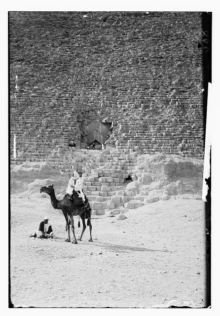 [Man on a camel in front of a pyramid?]