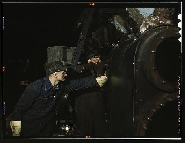 Working on the cylinder of a locomotive at the C & NW RR...