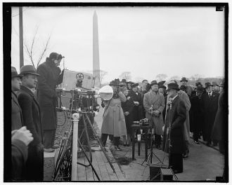 FCC Chairman faces lens of television camera. Washington,...