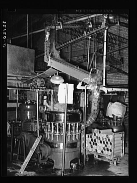 Cans are fed by gravity to a sterilizer and they are then...