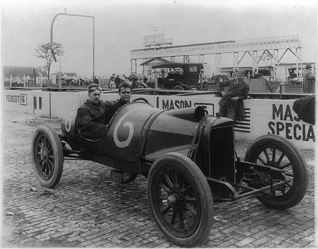 Unidentified men seated in racing cars