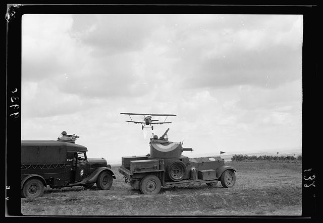 R.A.F. activities. Plane immediately above armoured car...