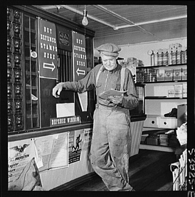 West Danville, Vermont. A farmer reading his mail at the...