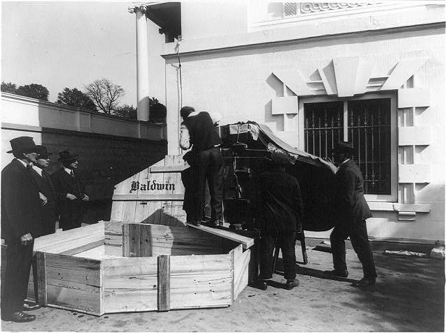 [Baldwin piano being unpacked from crate and moved into...