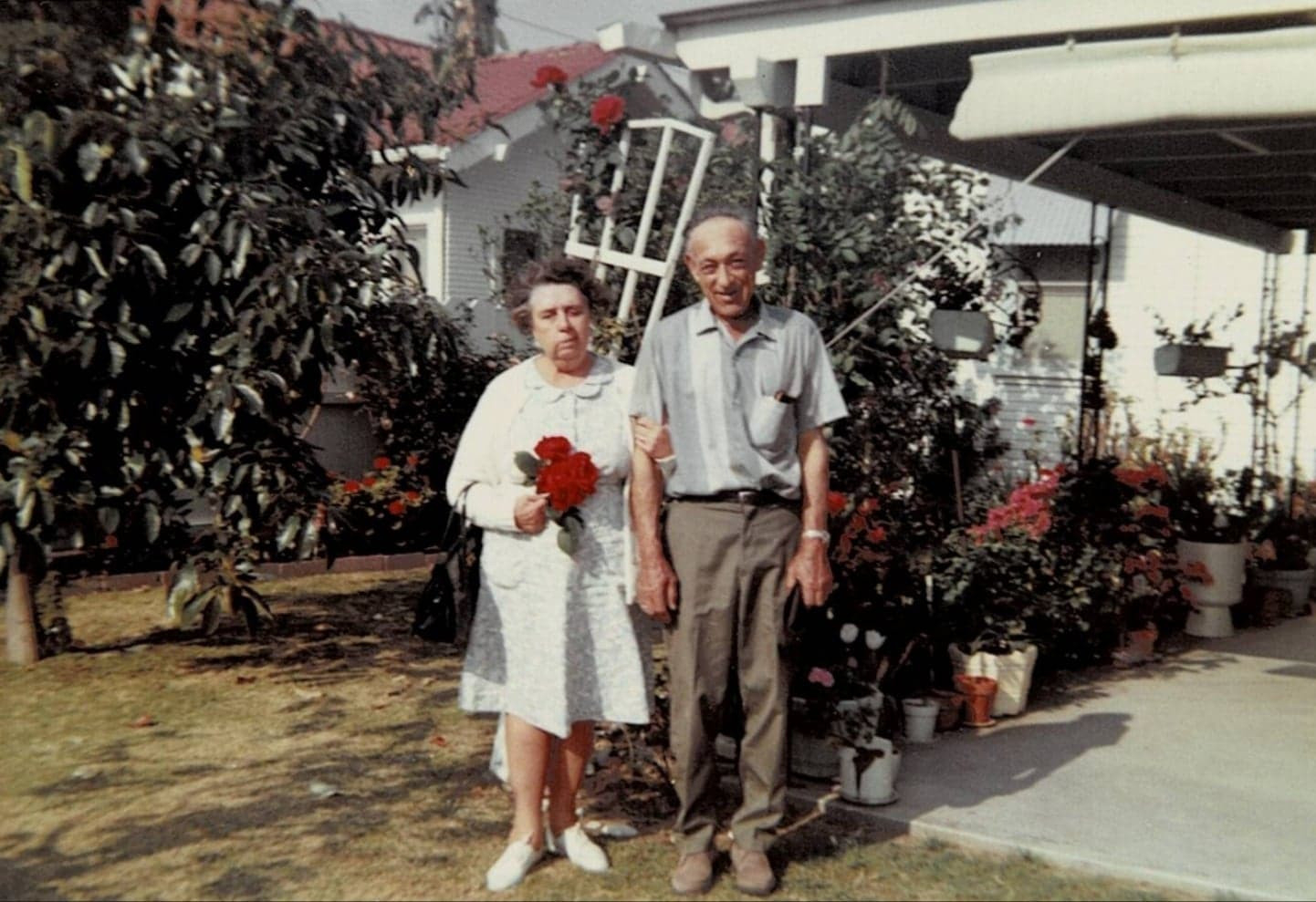 Cleota And her husband Tony standing it their backyard 