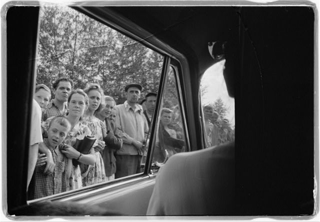 [Crowd of people looking in a car window in the Soviet...