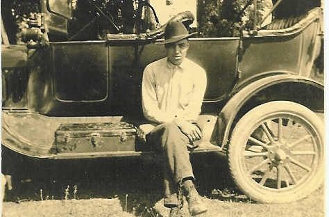 Ed Tyree Sitting On A Car's Running Board