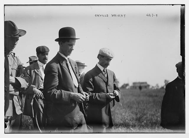 Orville Wright and crowd on flying field