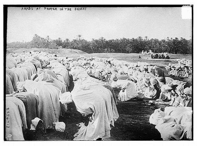 Arabs at prayer in desert