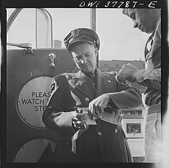Chicago, Illinois. A bus driver collecting tickets at the...