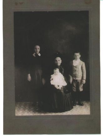 My maternal greatgreatgrandmother Adele (Chartier dit Robert) Meunier with her grandchildren. Standing Antoinette Campeau, my grandmother, her brother Charles standing and her sister Clarisse Campeau. 1910