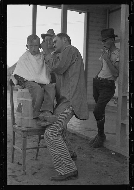 Community barber shop in Kern County migrant camp,...