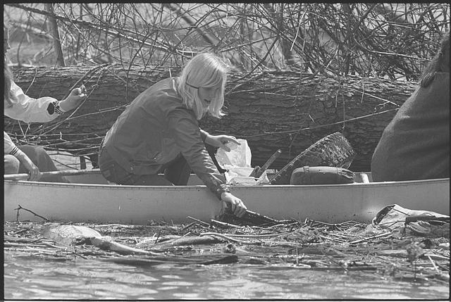 [Girl Scout in canoe, picking trash out of the Potomac...