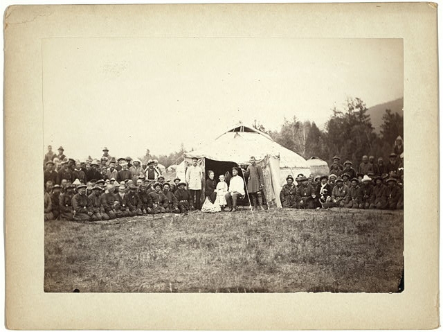 [Group of Kyrgyz men posing with a local Russian...