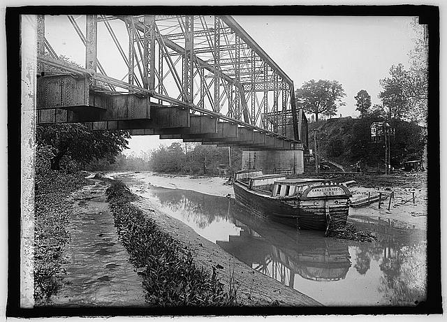 [View of canal and bridge with boat "Canal Towage Co.,...