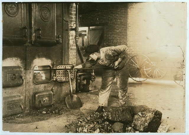 Stoking the furnace in the power-house. Pauls Valley...
