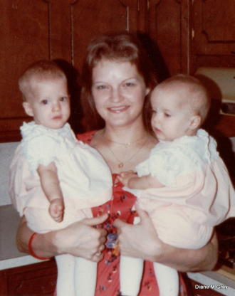 Brenda holding her twin daughters in NC