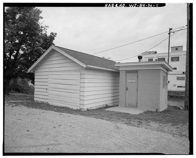 1. VIEW NORTHWEST, Garage on left, sanitary building...