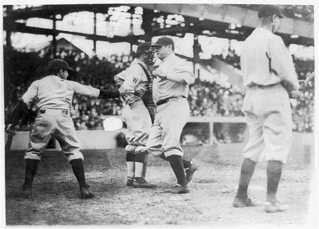 Babe Ruth crossing the plate after making his first home...
