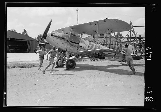 R.A.F. activities. Starting crew & pilot rushing to stand...