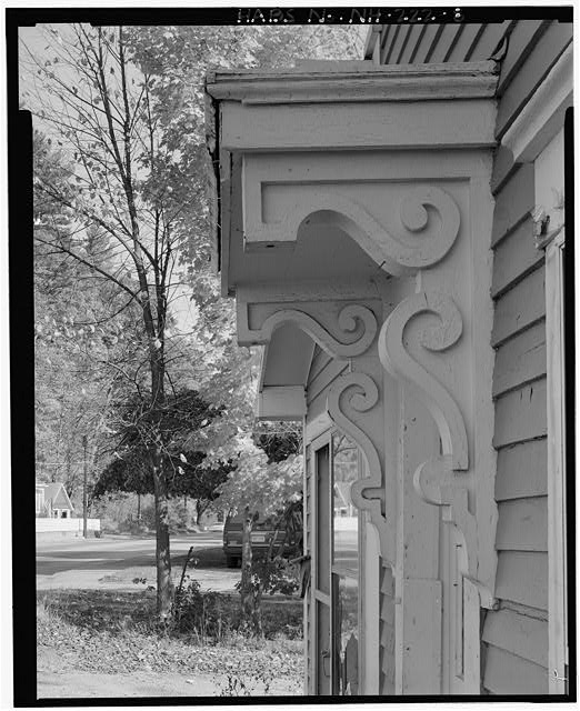 8. Detail of bracketed hood sheltering main entrance....