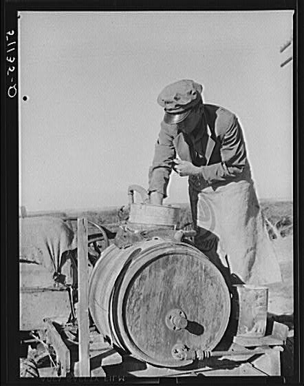 Migrant day laborer from Carolina mixing spray to kill...