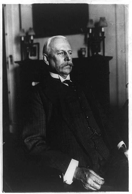 [Lionel Carden, half-length portrait, seated, facing right]