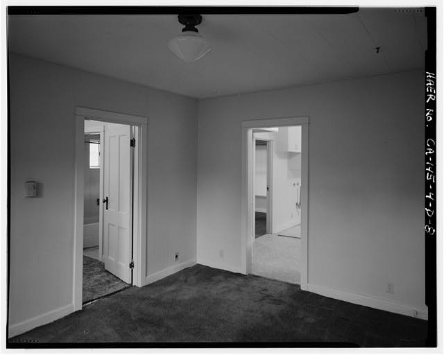 8. INTERIOR OF LIVING ROOM SHOWING DOORWAY TO KITCHEN AT...
