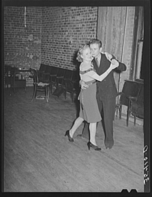 Young couple dancing at Jaycee buffet supper and party....