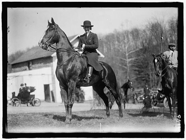 UNIDENTIFIED WOMAN ON HORSE
