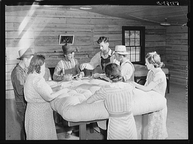Farmers and wives tufting mattress in making-unit....