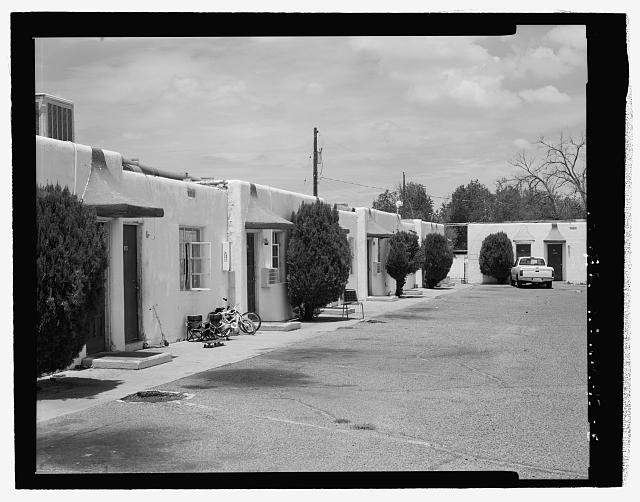 Closer view of west wing; note hole in asphalt indicating...