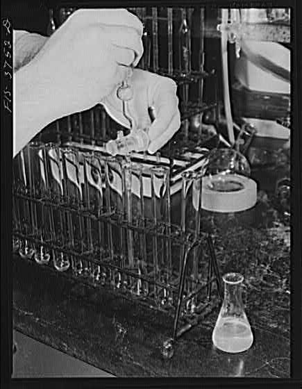 Drawing off solutions into test tubes in micro-biological...