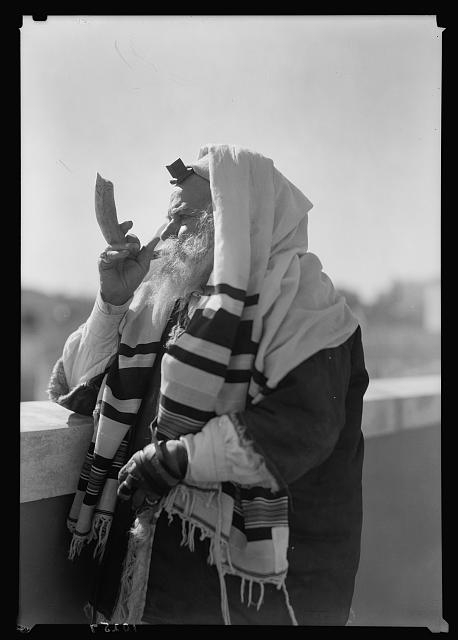 Yemenite Rabbi Avram arrayed for prayer, blowing the shofar