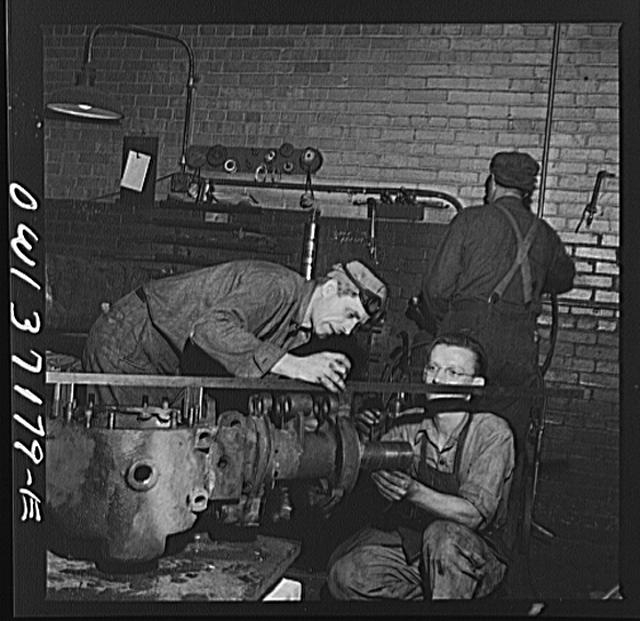 Pittsburgh, Pennsylvania. A mechanic working on a rear...