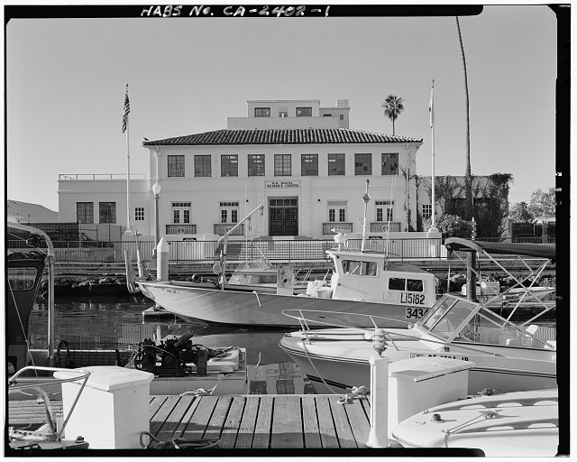 View of northeast front facade from small boat pier,...
