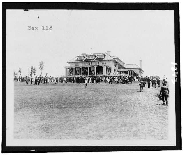 [Club house exterior and crowd on the Lawn of the...