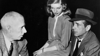 Howard Hawks discussing a scene with Lauren Bacall and Humphrey Bogart.