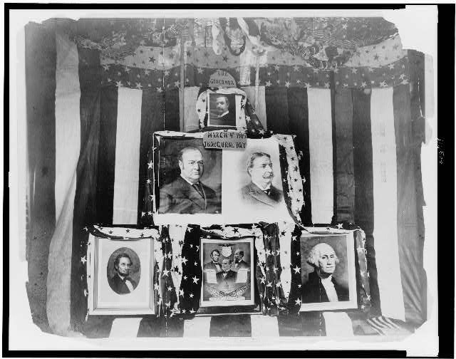 [Bunting serves as backdrop for a display of pictures of...