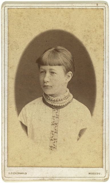 [Head-and-shoulders portrait of a young woman, facing left]
